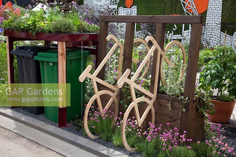 The RHS Greening Grey Britain Garden -  A bin store with living roof and a bike storage rack - RHS Chelsea Flower Show 2017