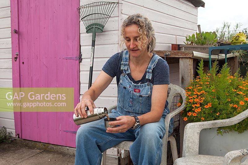 Wendy Gordon, Well Bean Gardening, Wendy sitting in leisure area pouring coffee