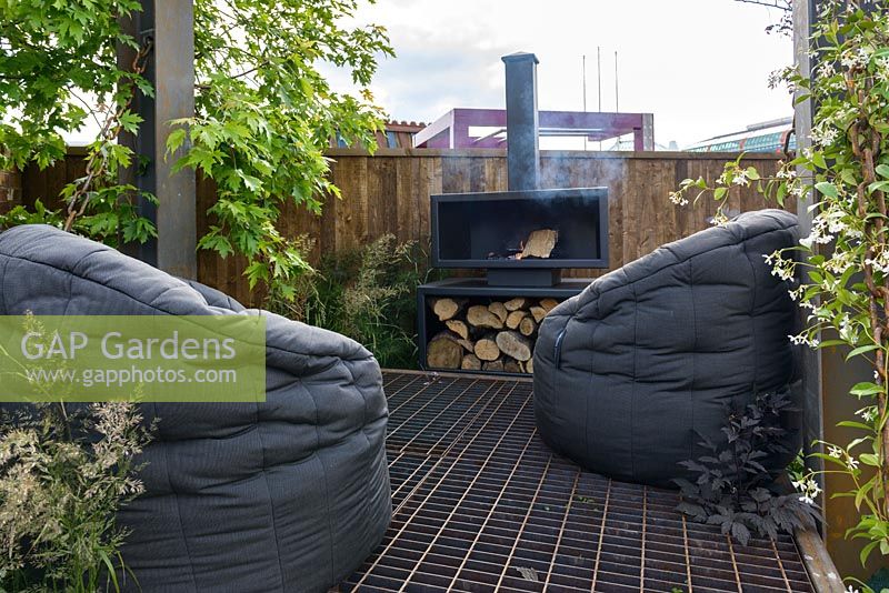 Floating lounging platform with bespoke steel wood burner and beanbags - BBC Gardener's World Live, Birmingham 2017 -Living Gardens 'Its Not Just About The Beard' Garden - Designer : Peter Cowell and Monty Richardson