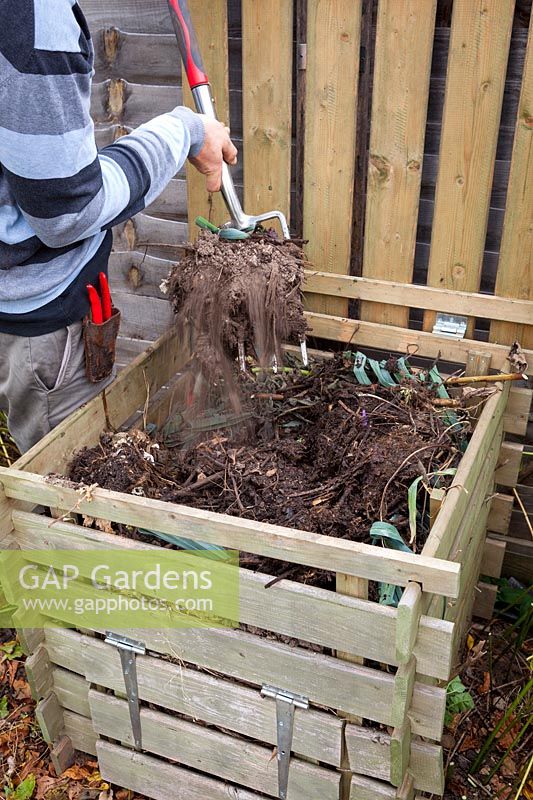 Turning over a compost heap with a fork