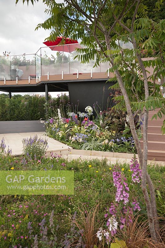 A small plot transformed by the use of a balcony to extend the space for planting and relaxing in the Live Garden at Tatton RHS Flower Show 2017