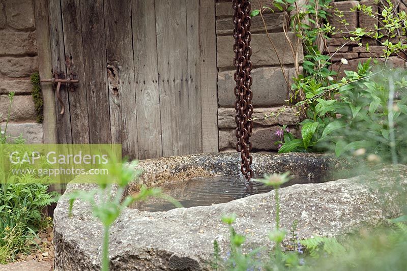 Stone water trough fountain with rain chain, Naturally Dry, William Wordsworth inspired drought tolerant and water saving garden, RHS Chelsea 2012.