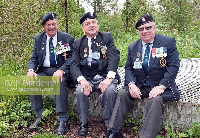 Ex-British soldiers with medals from the Korean War sitting in 'Quite Time', DMZ Forbidden Garden, RHS Chelsea, 2012.