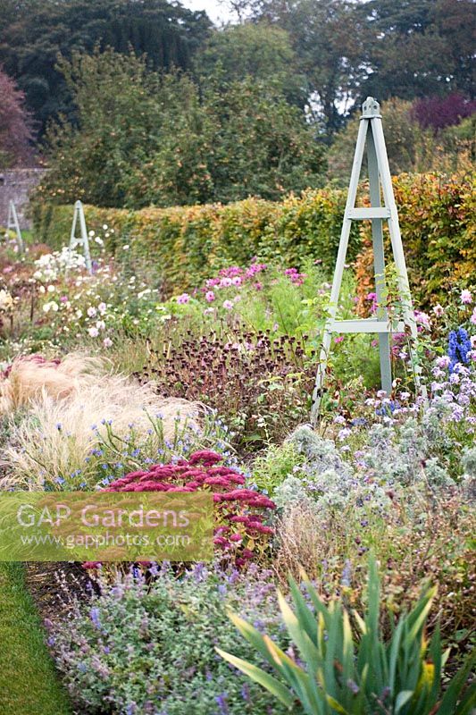 Herbaceous borders with a wooden obelisk in the walled garden at Castle Durrow, Co. Laois