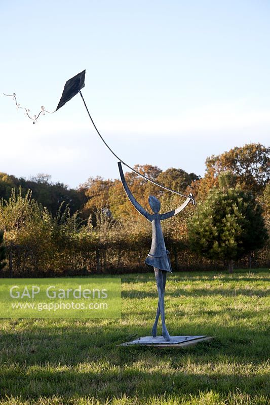 Girl flying a kite sculpture by Christopher Linsey  