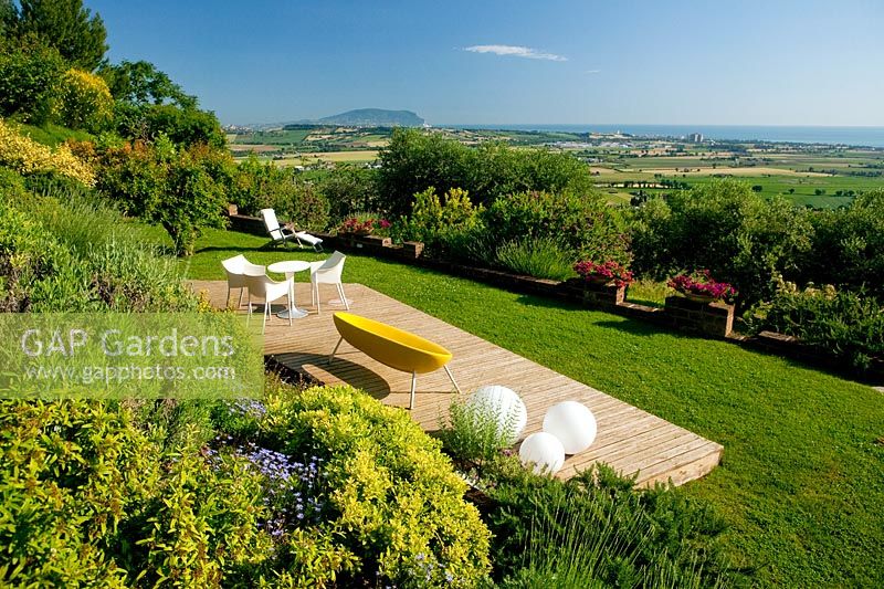 Larch footboard and outdoor living room. Project garden, Macerata, Italy.
