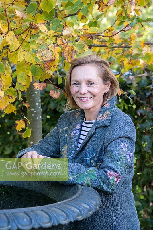 Susan Moffitt, garden designer, beneath a small leaved lime.