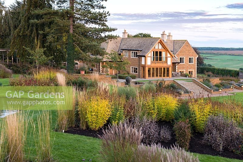 Prairie style beds with modern Arts and Crafts style house set in backdrop of Welland Valley.