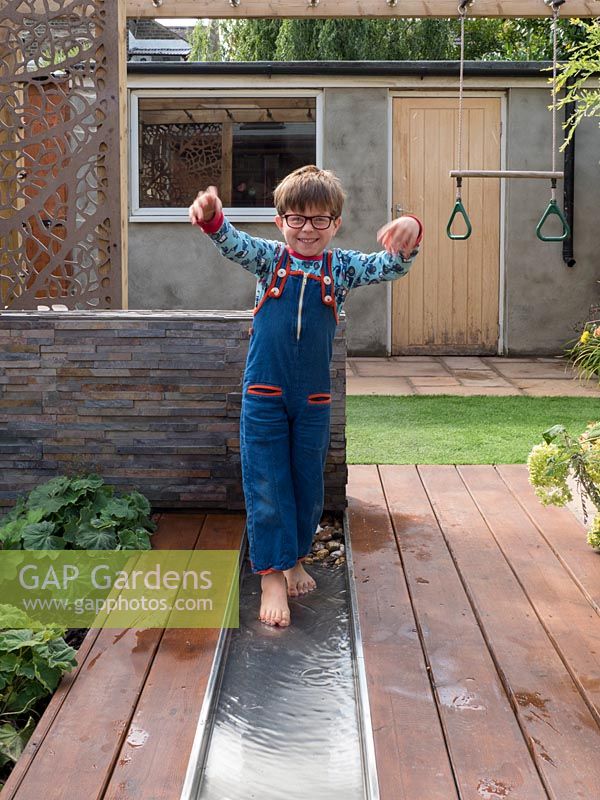 Oscar, the son of designer Katrina Kieffer-Wells plays in the garden