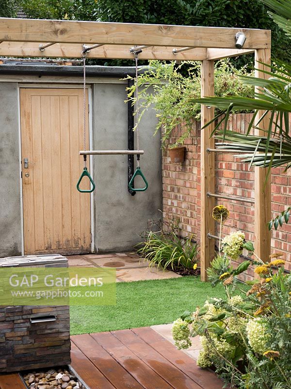Monkey bars and a trapeze were incorporated into this small family garden