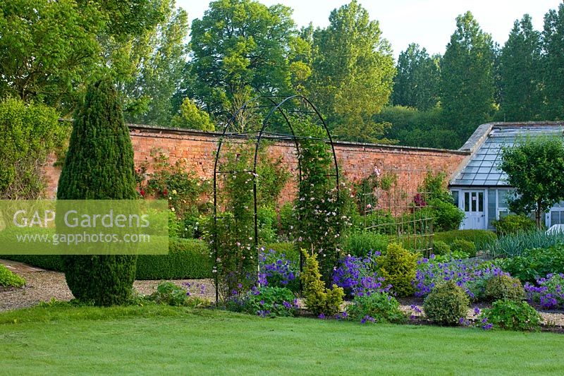Arch and borders at Little Ponton Hall, Lincolnshire, June.