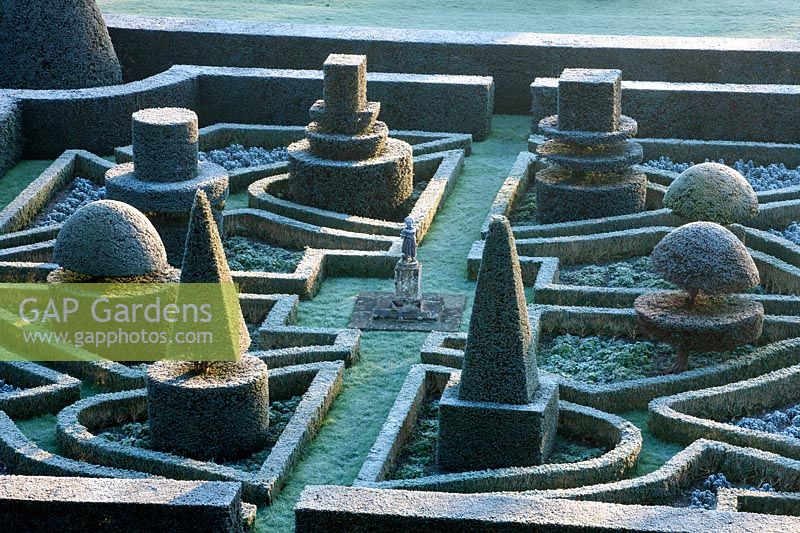 View over formal parterre with topiary in winter