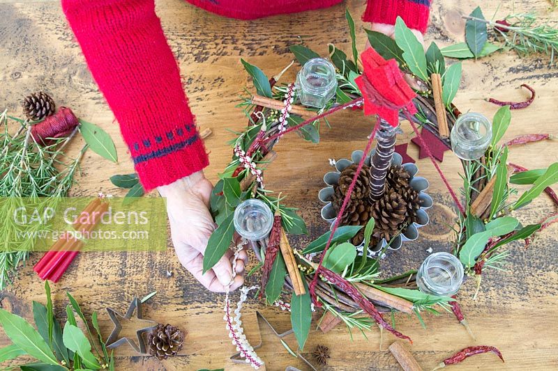 Wrapping decorative ribbon around wreath