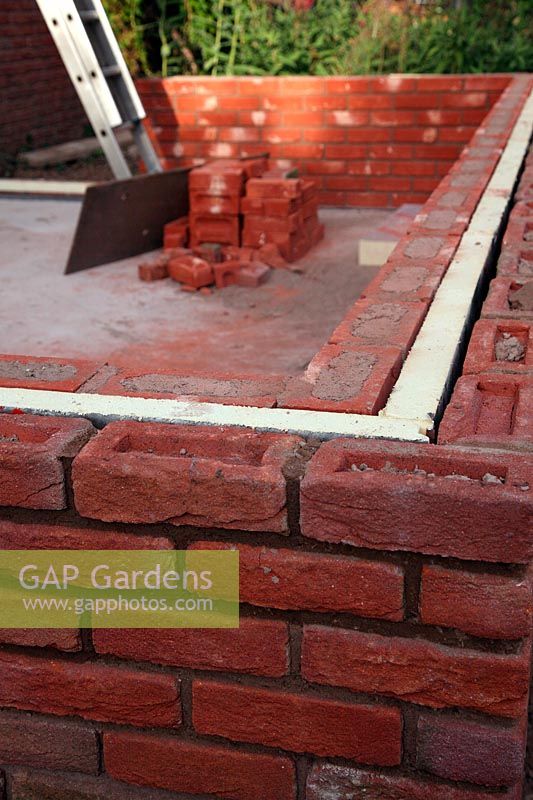 Constructing a conservatory - dwarf walls complete - bricks placed frog up to match extsiting building