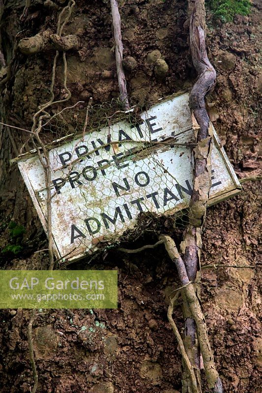 Private property - no admittance old sign pegged to a tree