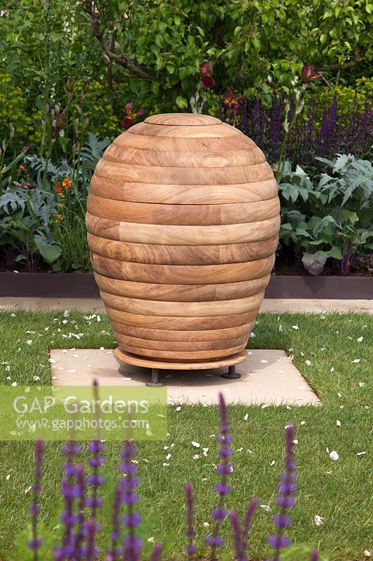Wooden beehive sculpture. The Homebase Garden, RHS Chelsea Flower Show. Designer: Adam Frost