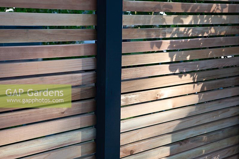 Contemporary louvred wooden garden fence