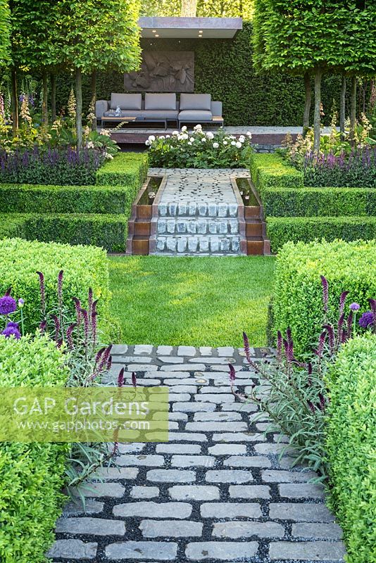 Stone paths and sunken lawn in Support, The Husqvarna Garden. Designer: Charlie Albone. RHS Chelsea Flower Show