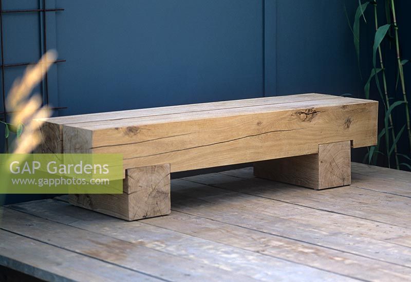 Contemporary oak wood minimalist garden bench seat. Lengths of dressed oak with block feet. RHS Hampton Court Flower Show
