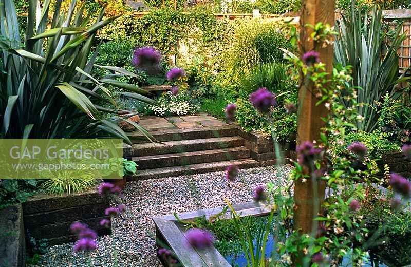 Patio garden with raised bed pool gravel paths architectural planting railway sleeper steps