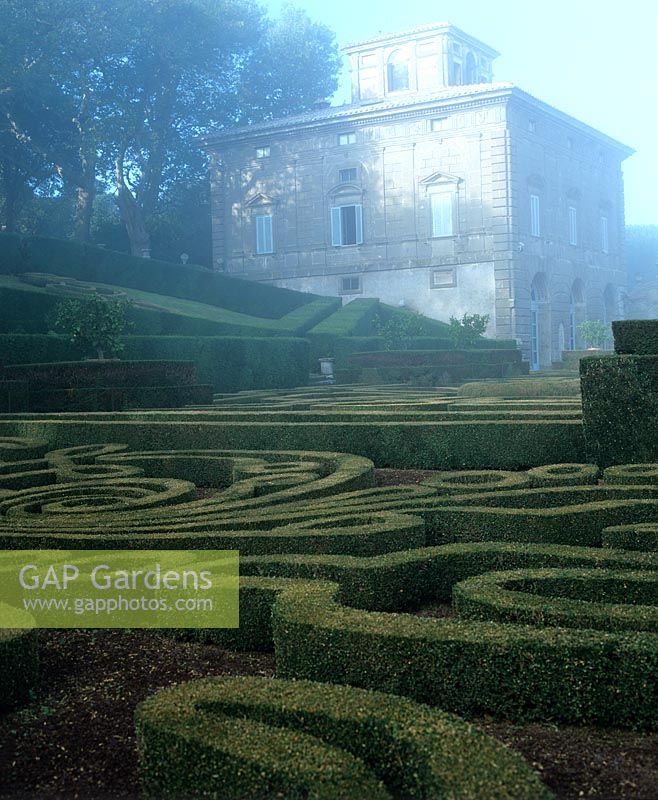 View of house over boxwood maze at Villa Lante Italy