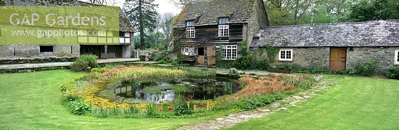 Penrhos Court Herefordshire home of Daphne Lambert Green Cuisine Old farm buildings large courtyard including pond  mown grass