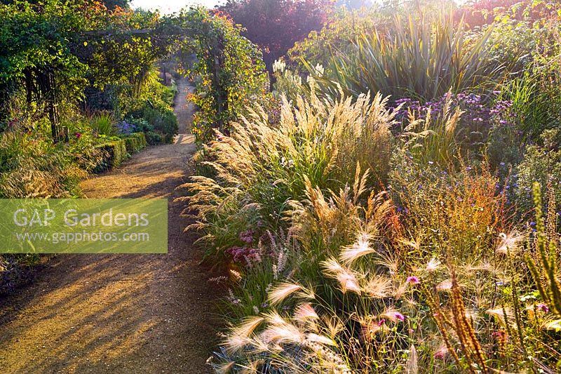 Cambo Walled garden, Fife, Scotland, UK, autumn, pathway, border, drift planting, ornamental grass, arch,