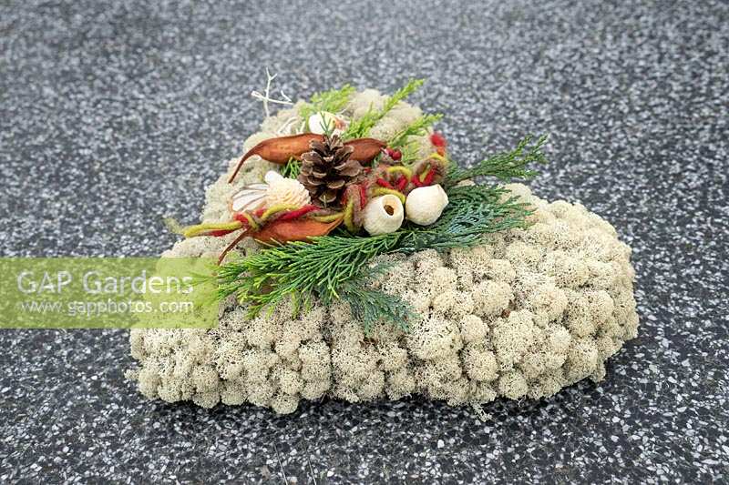 Grave decoration with moss heart arrangement