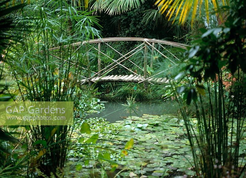 Bridge made of wood and bamboo sticks over a pond