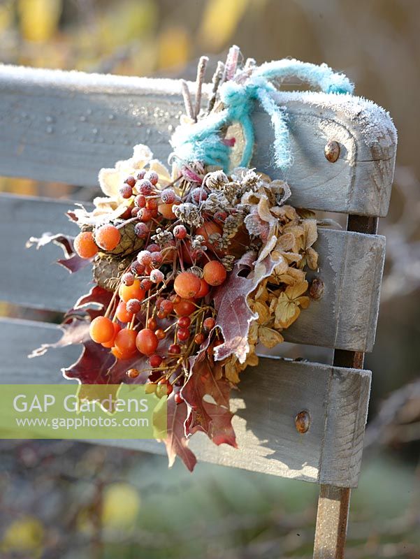 Frozen Autumn bouquet with Malus ( crab apples ), pink ( rose hips )