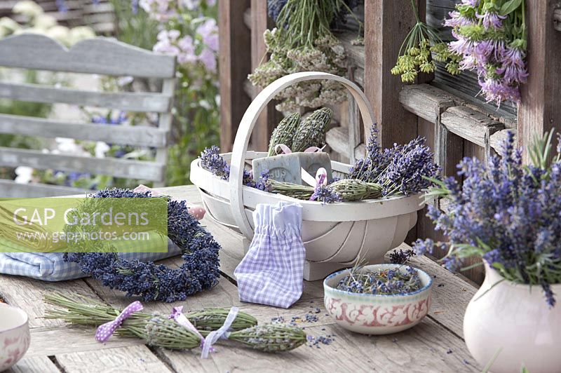Wreath of lavender ( Lavandula ) and basket of flowers, lavender bottles
