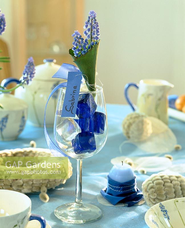Easter table decoration with Muscari - name tag in the wine glass,