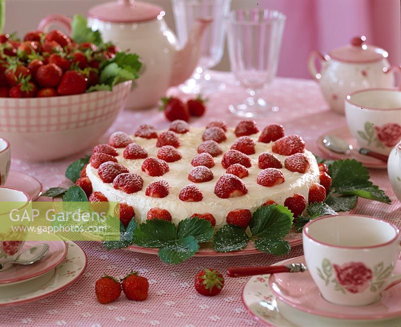 Strawberry cake decorated with fruits and leaves