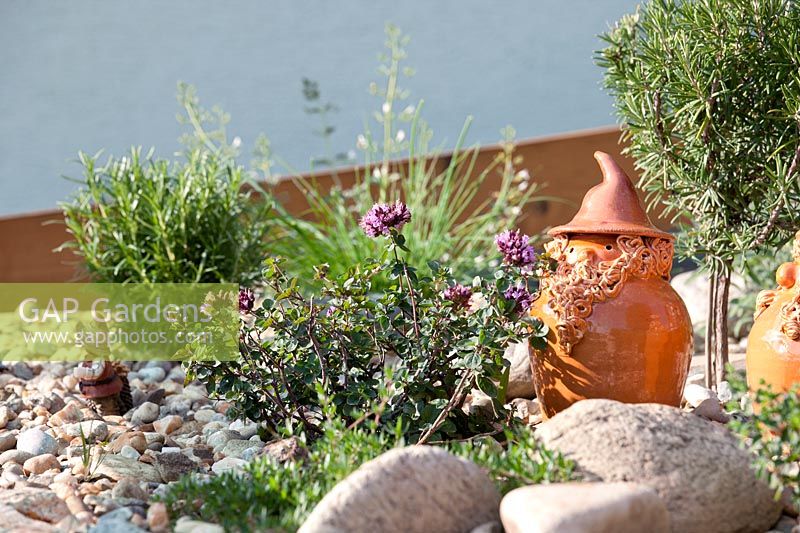 Herb garden with clay figure