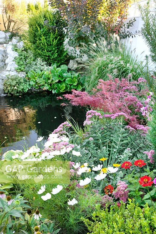 Colorful perennial garden with little pond
