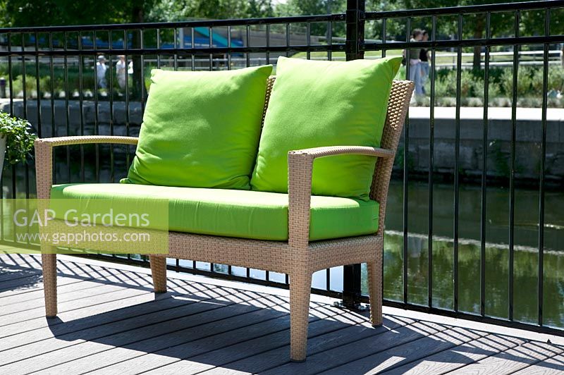 Garden bench with lime color pillows