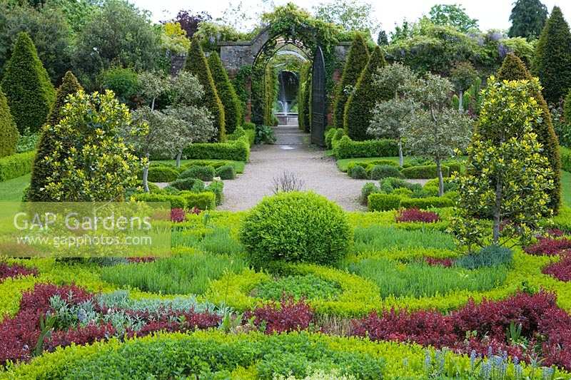 Abbey House Garden, Wiltshire, UK. Early summer, the knot garden with topiary and 'tapestry' style planting.