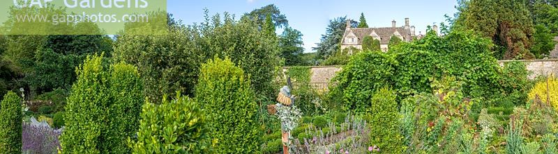 Barnsley House, Gloucestershire, UK. View of the house and potager in summer