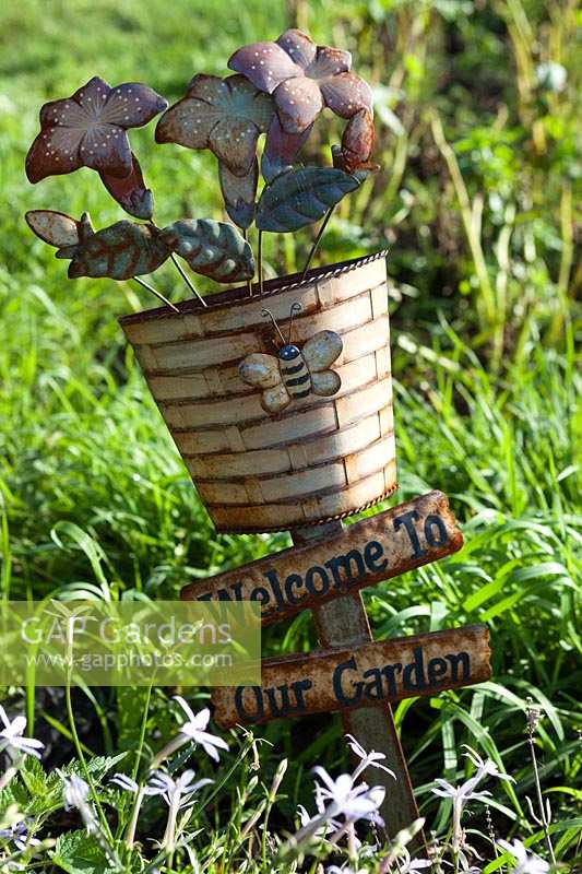 'Welcome to Our Garden' sign in vegetable garden