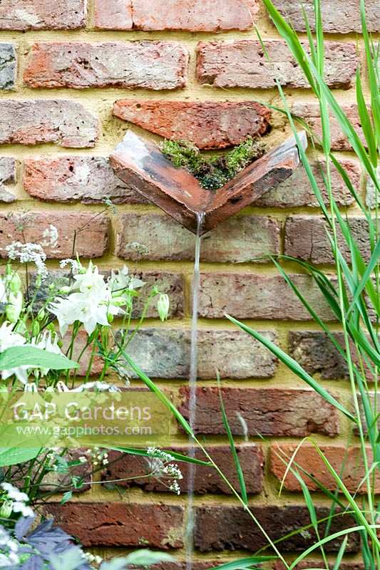Chelsea Flower Show, 2009. 'Jacob's Ladder' garden ( des. Jeff Hewitt ) simple brick wall water spout feature