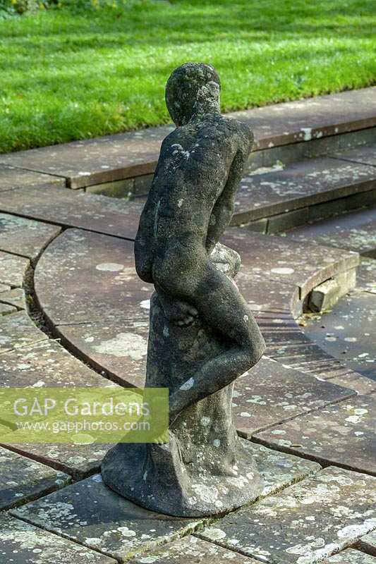 Statue of small boy at edge of formal pond, University of Bristol Botanic Garden