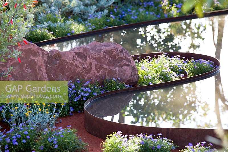 Hampton Court Flower Show 2014, the Essence of Australia Garden, des. Jim Fogarty. Curved reflective water feature pond