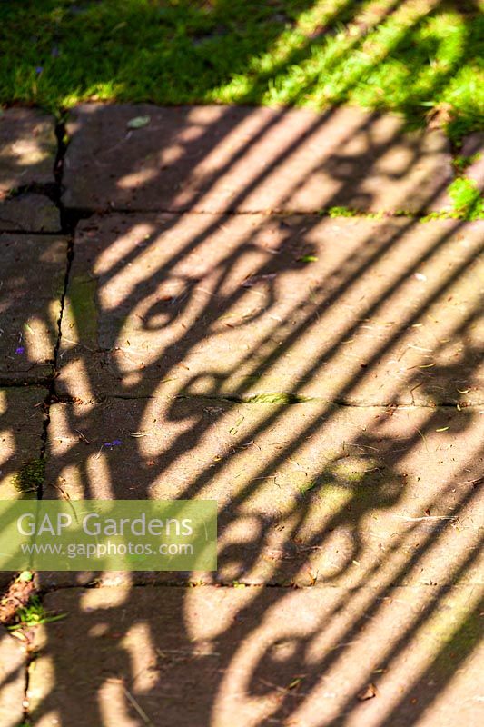 Peter Owen's garden, Watcombe, in Somerset, UK, shadow of elegant metal gate