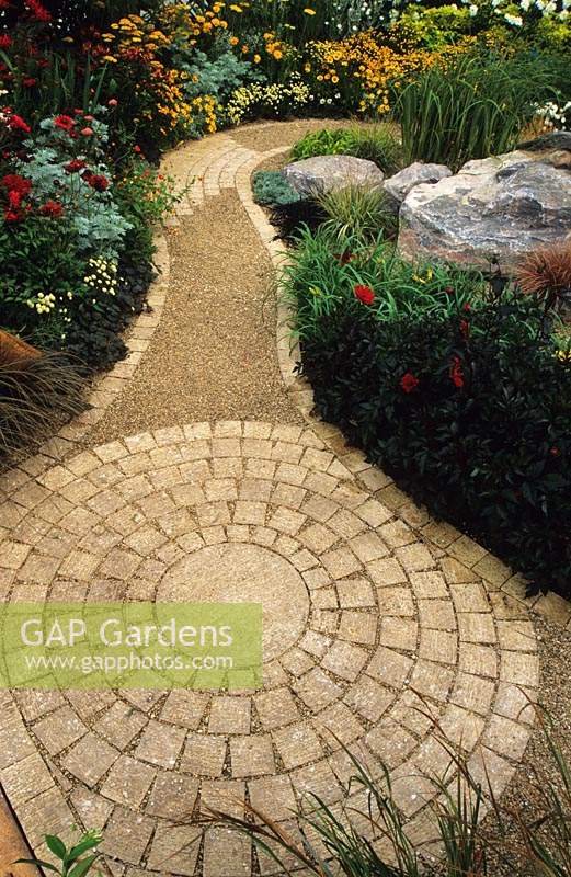 Feng Shui garden Design Pamela Woods Circular cobble design with winding path between colour theme borders