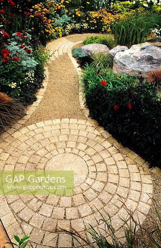 Feng Shui garden London Design Pamela Woods circular and curved sinuous cobble path in amongst colour themed borders