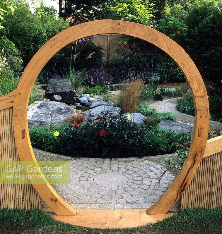 Feng Shui garden London Design Pamela Woods circular moon gate and cobbles curved sinuous cobble path gravel rock garden area