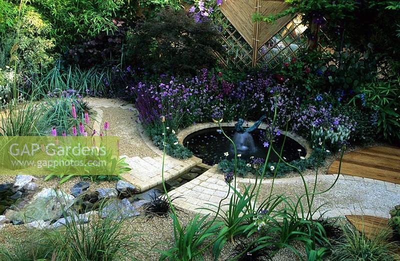 Feng Shui garden London Design Pamela Woods cool colour area circular pond with statue fountain curved sinuous cobble path