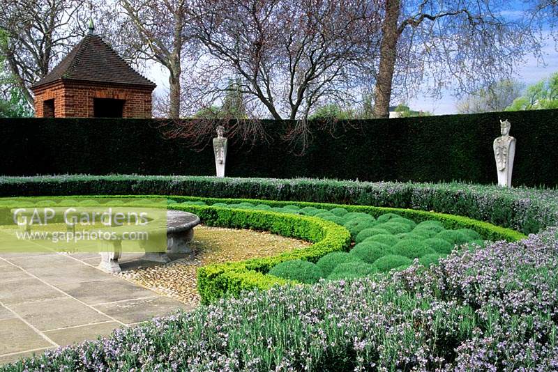 Kew Gardens Surrey the Queen s Garden curved stone bench hedges of yew boxwood rosemary and santollina statues
