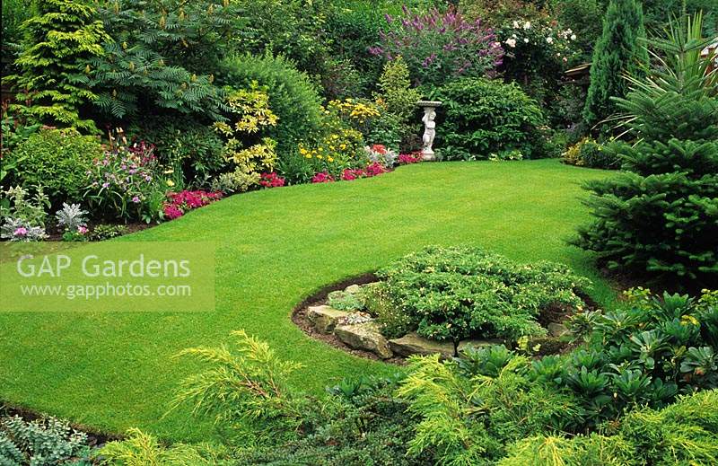 private garden Wolverhampton lawn in gently sloping garden with conifers and statue