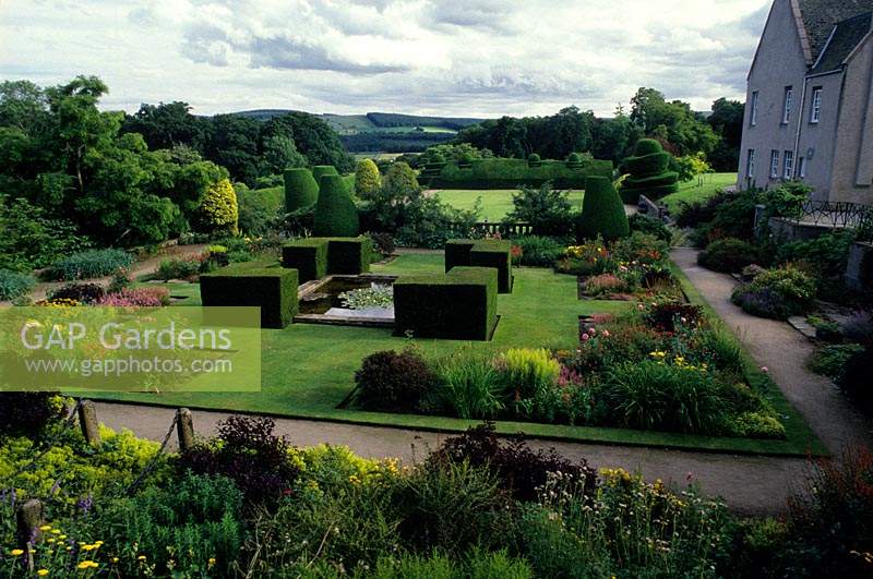 Crathes Castle Scotland formal lawns and yew hedge surrounding pond Colour themes borders